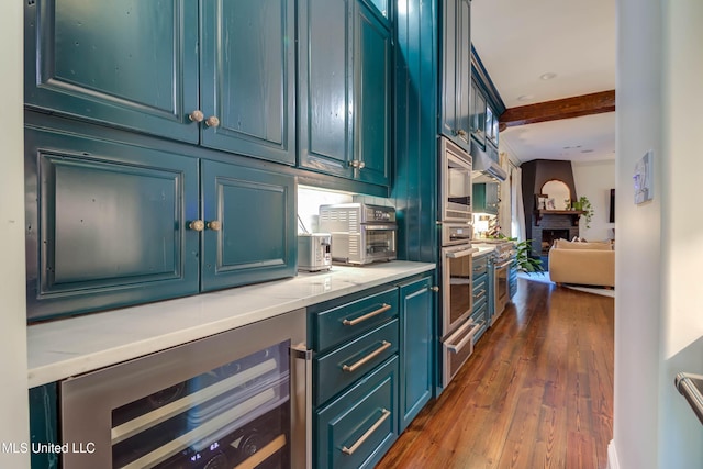 bar with dark wood-style floors, beverage cooler, a toaster, oven, and a warming drawer