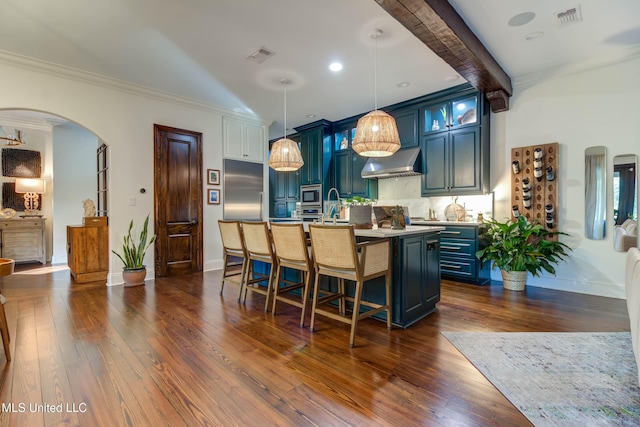 kitchen with extractor fan, blue cabinetry, visible vents, and appliances with stainless steel finishes