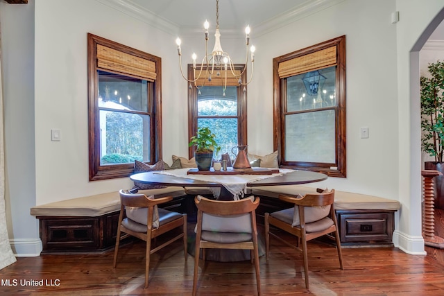 dining area with a notable chandelier, wood finished floors, baseboards, and ornamental molding