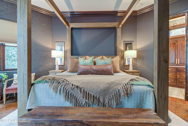 bedroom featuring crown molding and wood finished floors