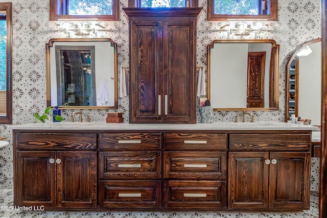 full bath with wallpapered walls, double vanity, and plenty of natural light