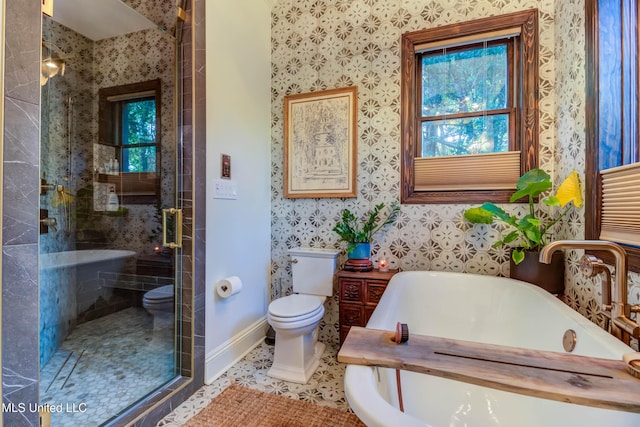 full bathroom featuring baseboards, wallpapered walls, a soaking tub, a shower stall, and toilet