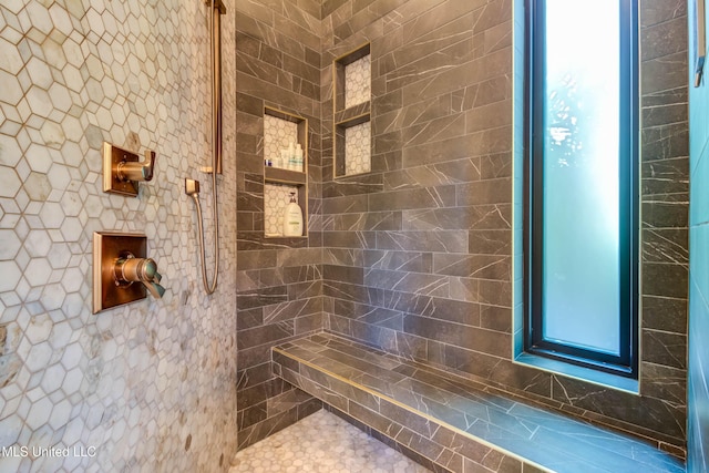 bathroom with tiled shower