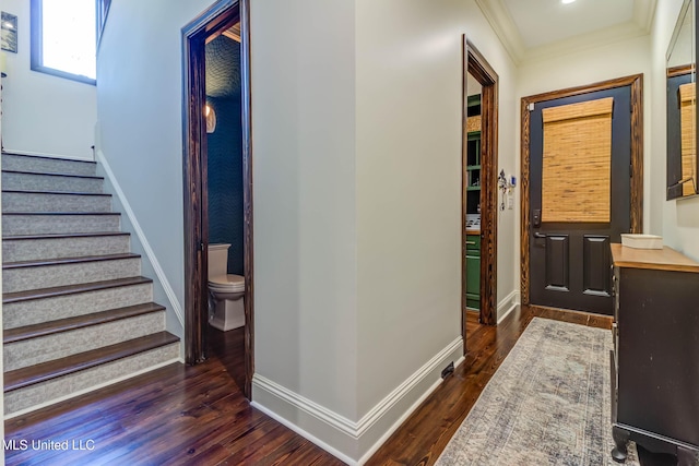 entrance foyer with stairway, baseboards, dark wood-style floors, and crown molding