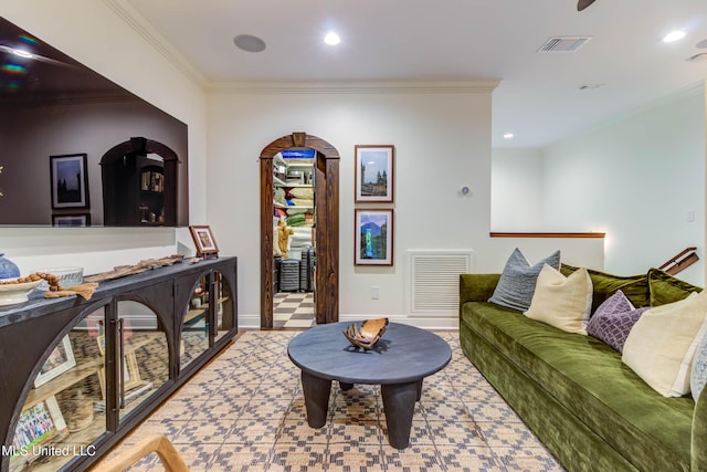 living room with baseboards, recessed lighting, visible vents, and ornamental molding