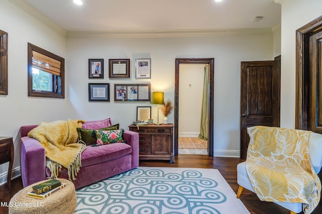 living room featuring ornamental molding, baseboards, and wood finished floors