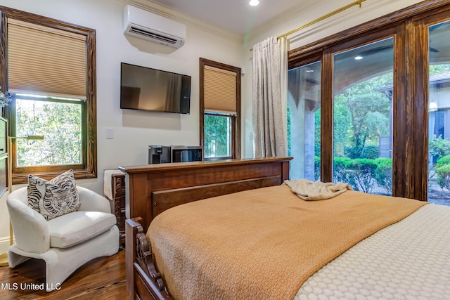 bedroom featuring access to outside, crown molding, a wall mounted AC, and wood finished floors