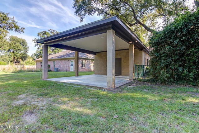 back of property with a yard, fence, cooling unit, and a patio area