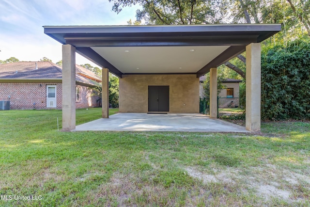 back of house featuring a lawn and a patio