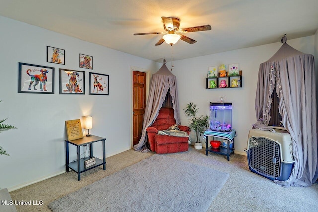 rec room featuring carpet floors, a ceiling fan, and baseboards