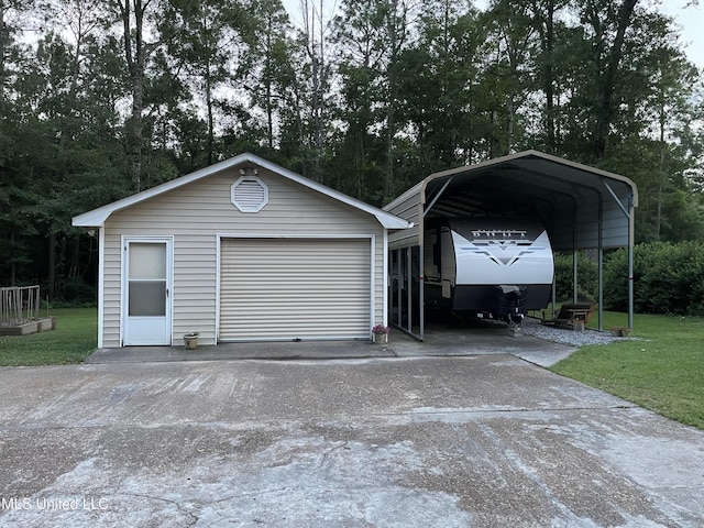 6324 Country Ln, Moss Point, MS 39562 - detached garage with concrete driveway and a carport