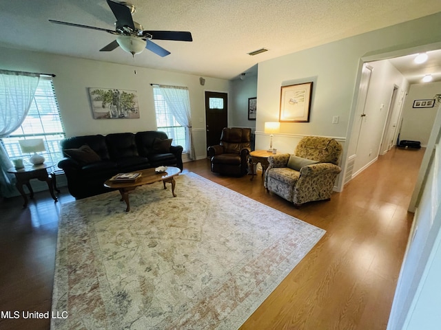 6324 Country Ln, Moss Point, MS 39562 - living area with ceiling fan, wood finished floors, and a textured ceiling