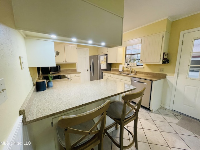 6324 Country Ln, Moss Point, MS 39562 - kitchen with appliances with stainless steel finishes, a peninsula, a sink, crown molding, and a kitchen breakfast bar