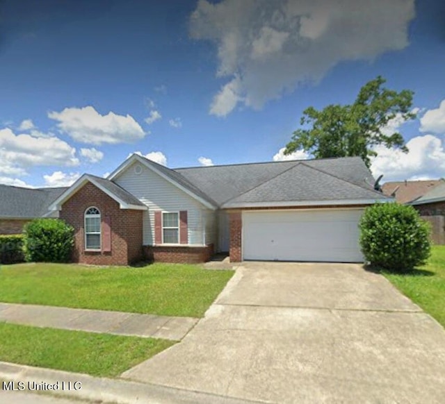 14427 Williamsburg Dr, Gulfport, MS 39503 - ranch-style home with an attached garage, driveway, brick siding, and a front yard