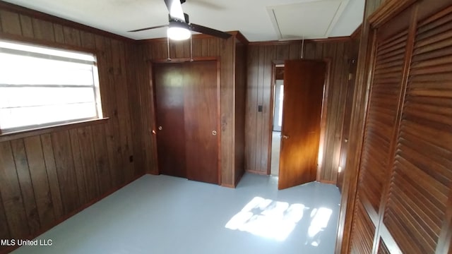 2610 Demaret Dr, Gulfport, MS 39507 - unfurnished bedroom with attic access, wood walls, a closet, and ceiling fan