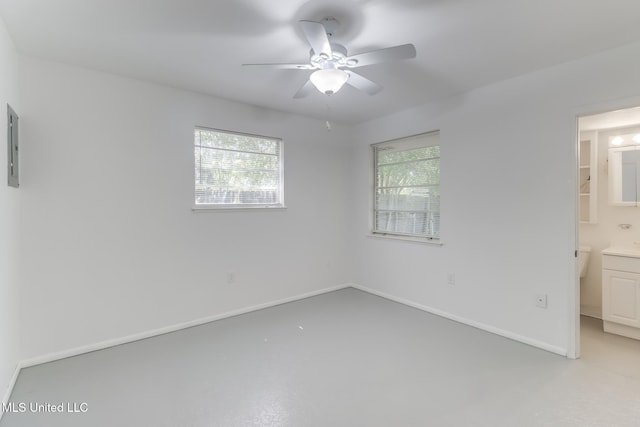 2610 Demaret Dr, Gulfport, MS 39507 - unfurnished bedroom with multiple windows, concrete flooring, baseboards, and ensuite bathroom