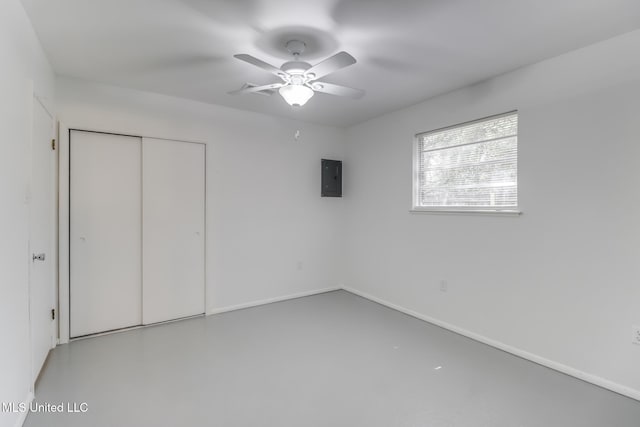 2610 Demaret Dr, Gulfport, MS 39507 - unfurnished bedroom featuring electric panel, a closet, concrete floors, baseboards, and ceiling fan