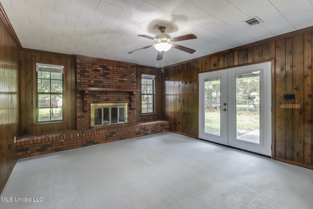 2610 Demaret Dr, Gulfport, MS 39507 - unfurnished living room featuring wooden walls, french doors, carpet, plenty of natural light, and crown molding