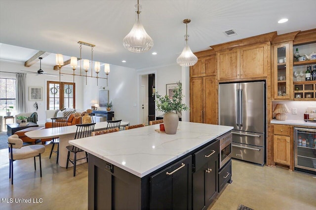 kitchen featuring beverage cooler, stainless steel appliances, visible vents, brown cabinetry, and decorative light fixtures