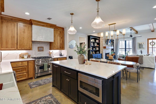 kitchen with a fireplace, stainless steel appliances, backsplash, open floor plan, and concrete flooring