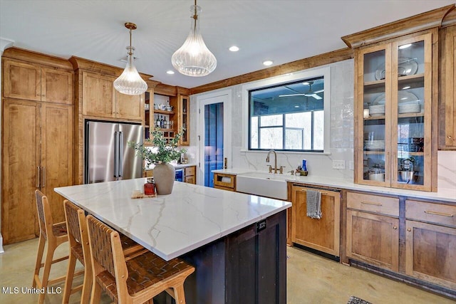 kitchen featuring open shelves, brown cabinetry, a kitchen island, high quality fridge, and a sink