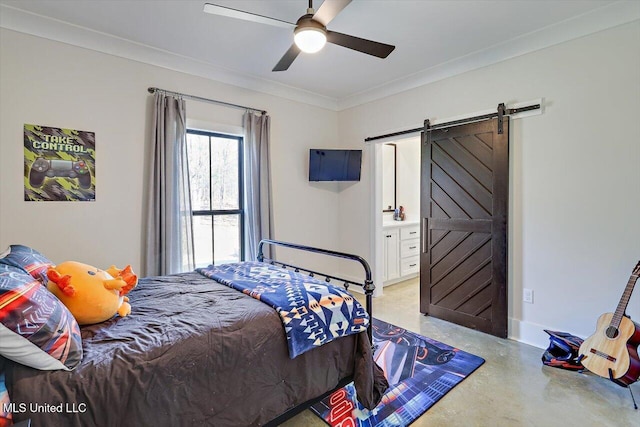 bedroom featuring ensuite bathroom, a barn door, concrete floors, a ceiling fan, and ornamental molding