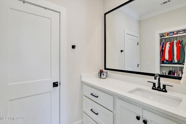 bathroom with visible vents, a closet, and vanity