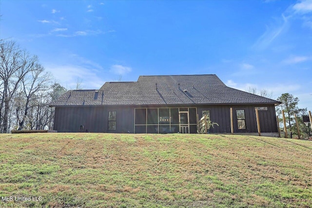 rear view of property featuring a sunroom and a yard