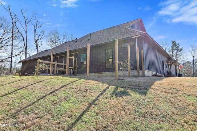 back of house with a lawn