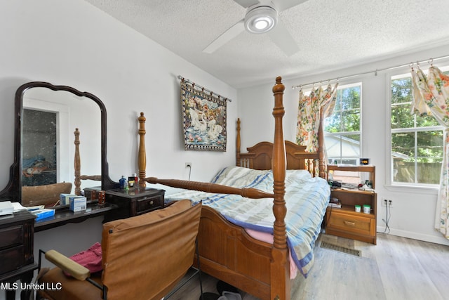 3902 Pascagoula St, Pascagoula, MS 39567 - bedroom with a textured ceiling, wood finished floors, a ceiling fan, and baseboards