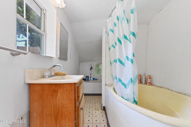 3902 Pascagoula St, Pascagoula, MS 39567 - full bathroom featuring tile patterned floors, vanity, vaulted ceiling, and shower / bathtub combination with curtain