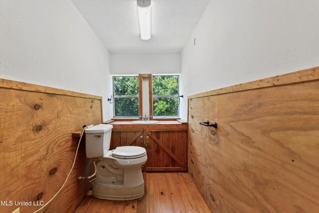 3902 Pascagoula St, Pascagoula, MS 39567 - half bathroom featuring toilet, hardwood / wood-style flooring, and a sink
