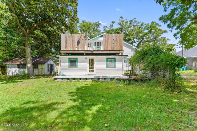 3902 Pascagoula St, Pascagoula, MS 39567 - rear view of house featuring a wooden deck, a lawn, and an outbuilding