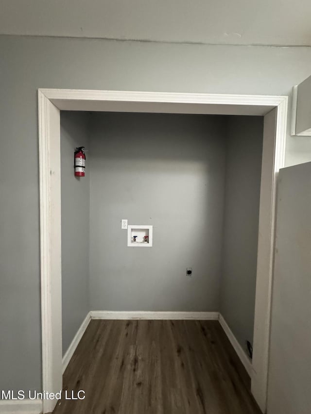 laundry area with hookup for a washing machine, hookup for an electric dryer, baseboards, and dark wood-style flooring