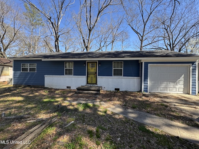 ranch-style house featuring an attached garage, brick siding, driveway, and crawl space