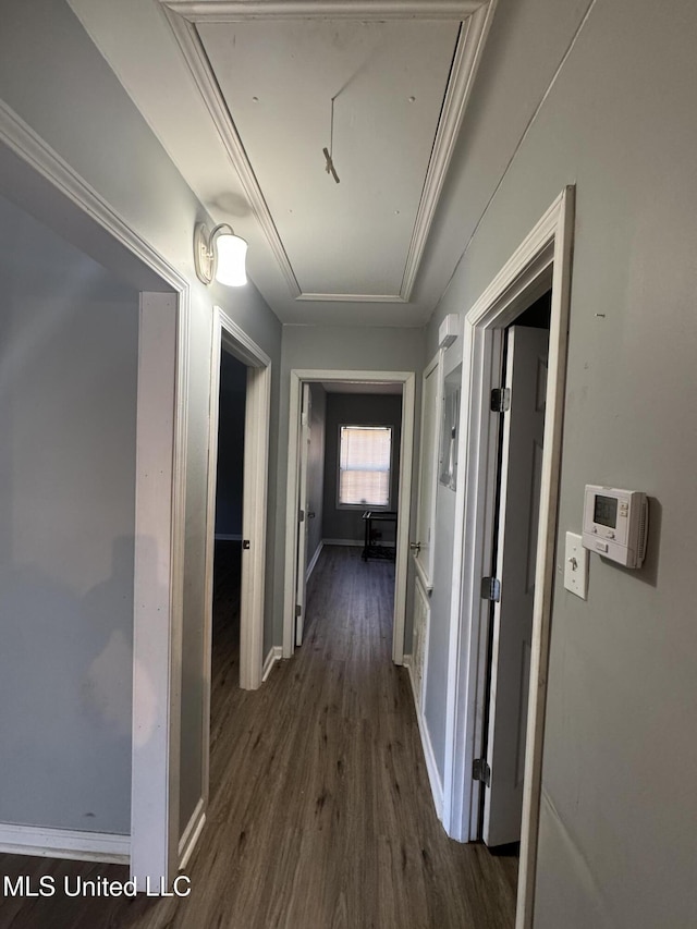 hall featuring dark wood finished floors, attic access, and baseboards