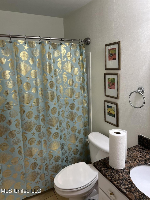 bathroom with walk in shower, vanity, toilet, and tile patterned flooring