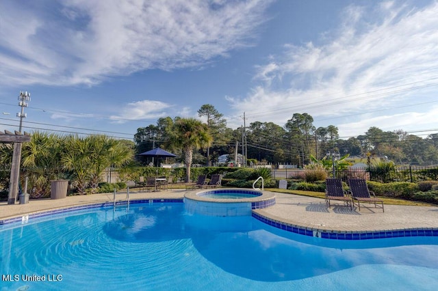 view of swimming pool with a patio and a community hot tub