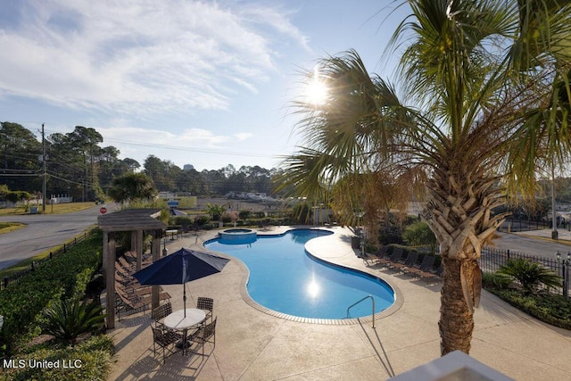 view of pool with a community hot tub and a patio area