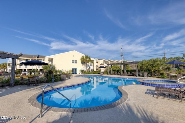 view of pool featuring a hot tub, a patio area, and a pergola