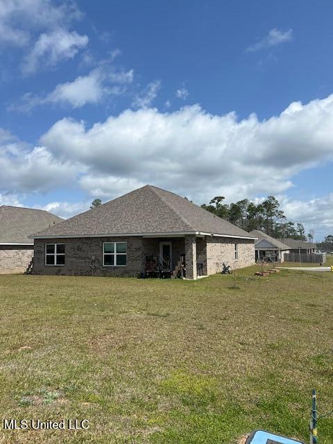 rear view of property with a yard