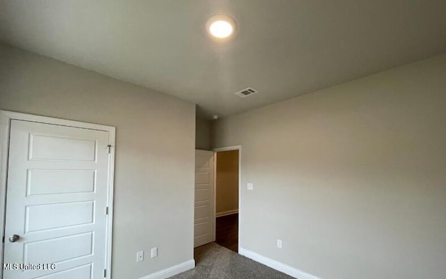 unfurnished bedroom featuring visible vents, baseboards, and carpet floors