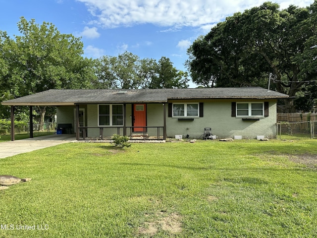 ranch-style house featuring brick siding, fence, driveway, a carport, and a front lawn