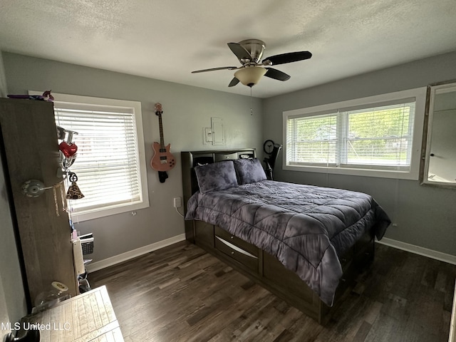 bedroom with a textured ceiling, ceiling fan, dark wood finished floors, and baseboards