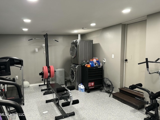 exercise area with recessed lighting and stacked washing maching and dryer