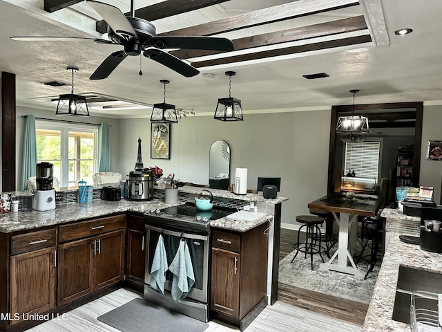 kitchen featuring electric range, visible vents, pendant lighting, and dark brown cabinets