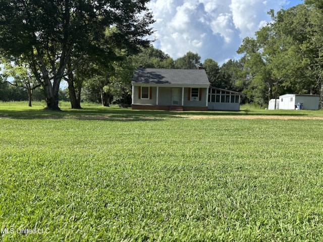 232 Renfroe Rd, Canton, MS 39046 - view of front of home with a front lawn, view of scattered trees, covered porch, and an outdoor structure
