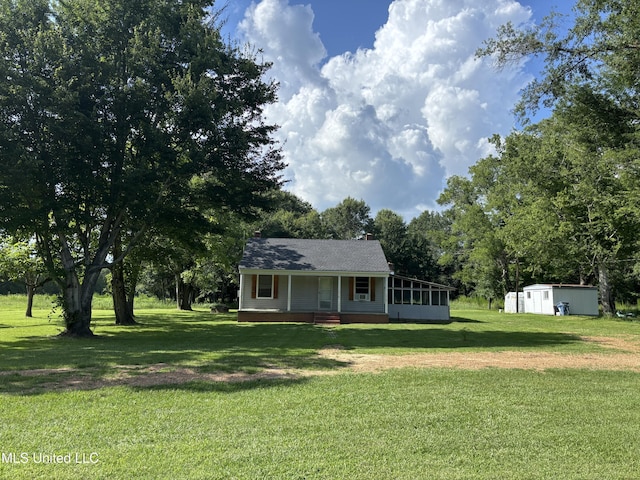 232 Renfroe Rd, Canton, MS 39046 - view of front of property featuring a porch, a front yard, a chimney, a storage unit, and view of scattered trees