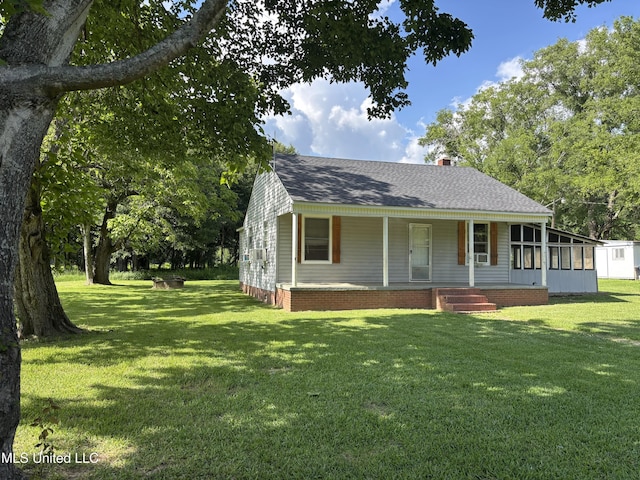 232 Renfroe Rd, Canton, MS 39046 - view of front facade with covered porch, a front yard, roof with shingles, and a chimney