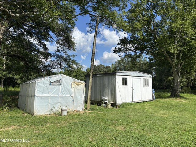 232 Renfroe Rd, Canton, MS 39046 - view of outbuilding featuring view of wooded area
